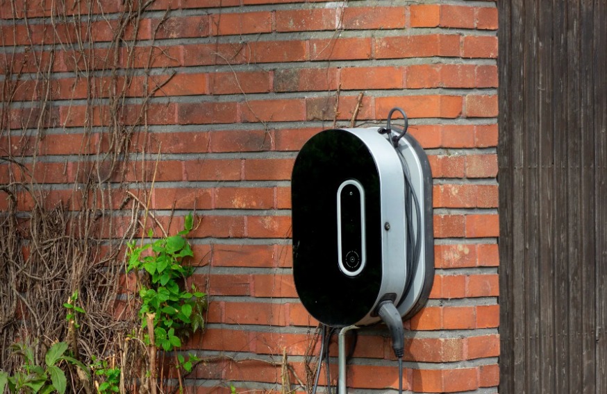 Home EV charger mounted on a brick wall